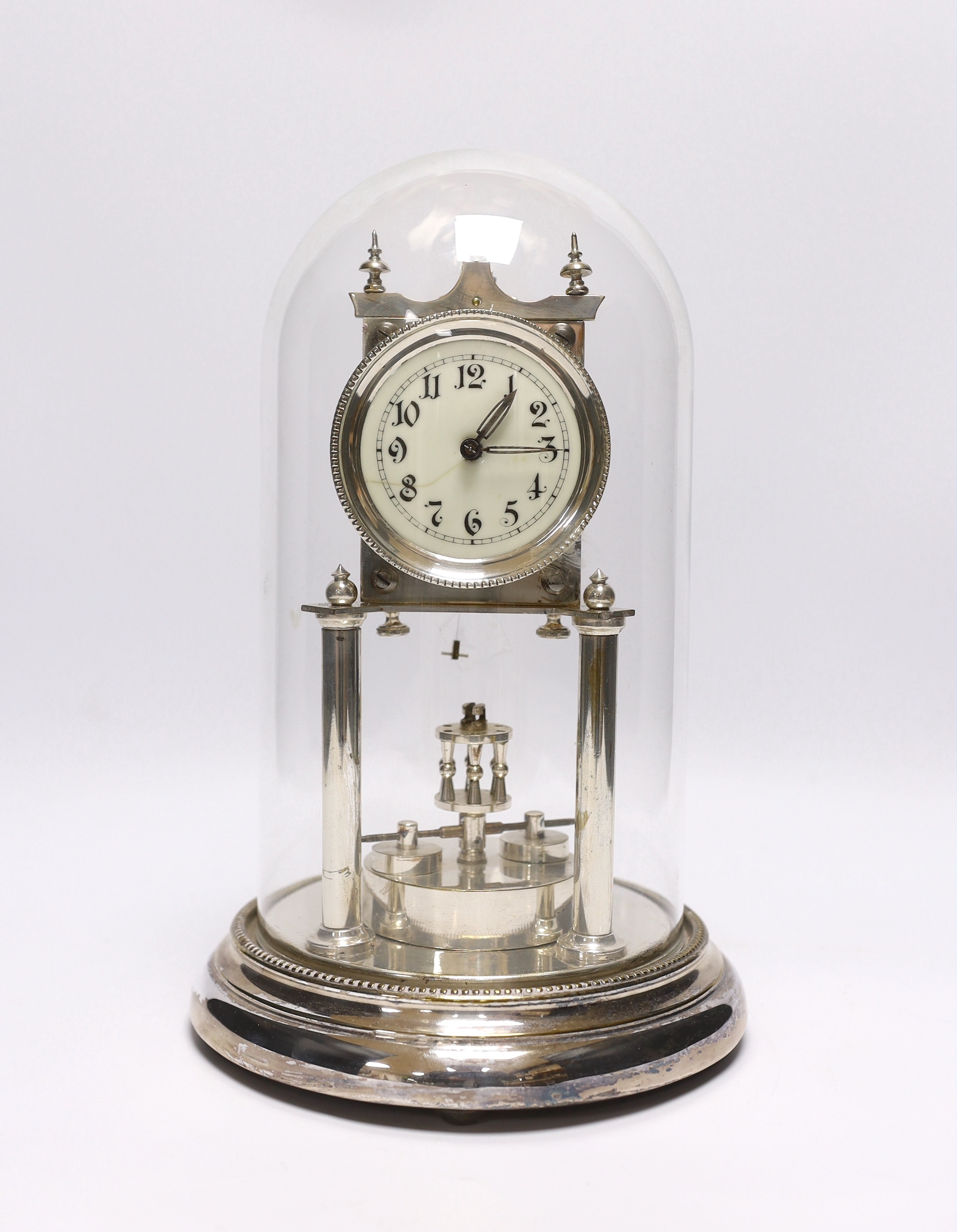 A chrome plated skeleton clock under dome, 29cm